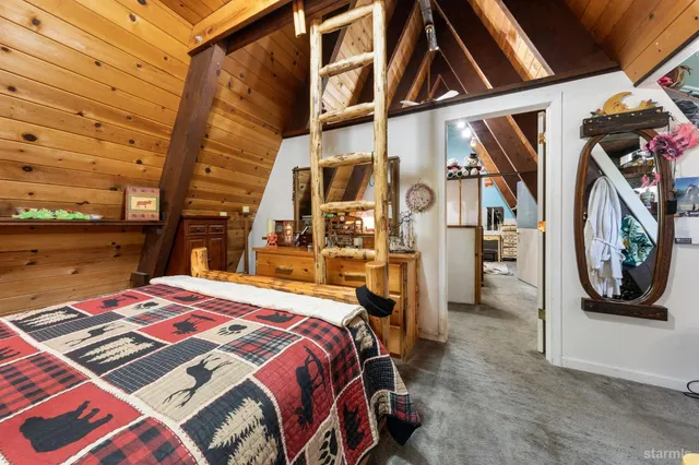 a bed sitting in a bedroom next to a window