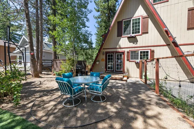 a view of a house with backyard sitting area and porch