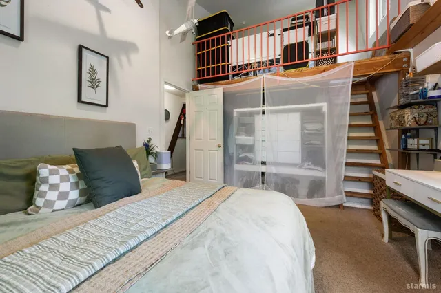 a bedroom with a bed and a window