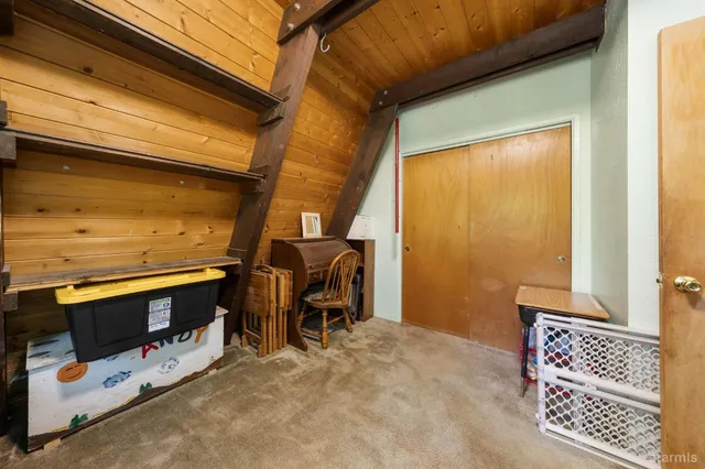 a bedroom with furniture and a large window