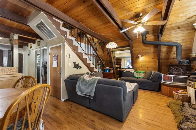 a living room with furniture and a dining table