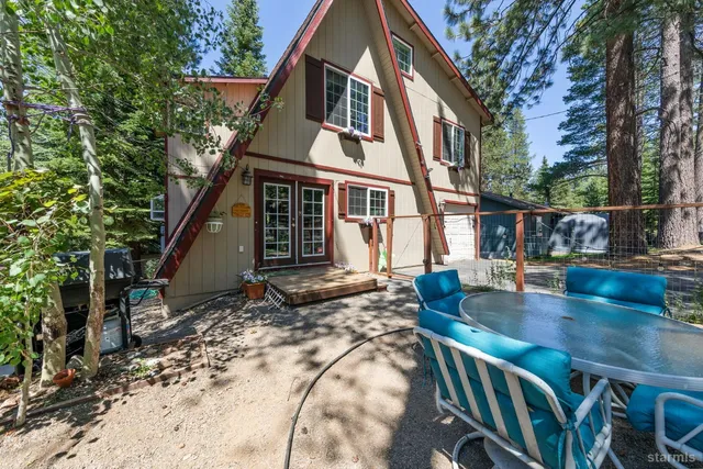 a view of a house with a yard garage and sitting area