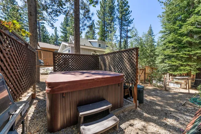 a view of house with a yard and large trees