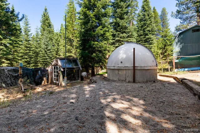 a view of a house with a yard and tree