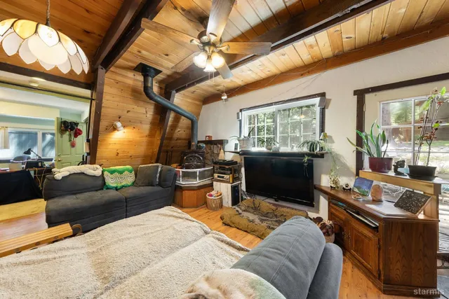 a living room with furniture fireplace and a large window
