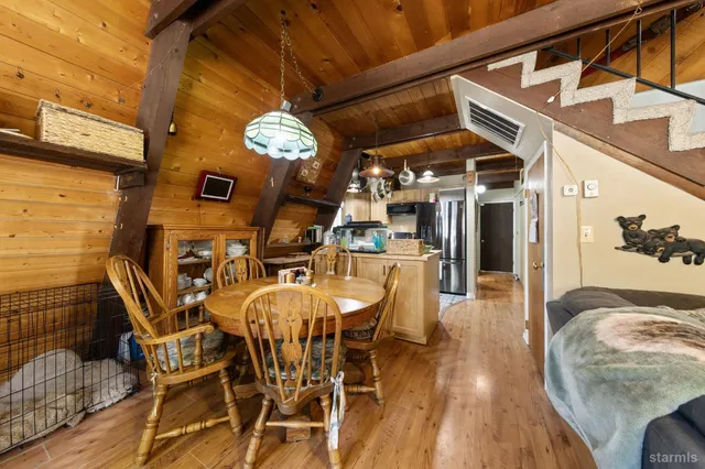 a view of a dining room with furniture and chandelier