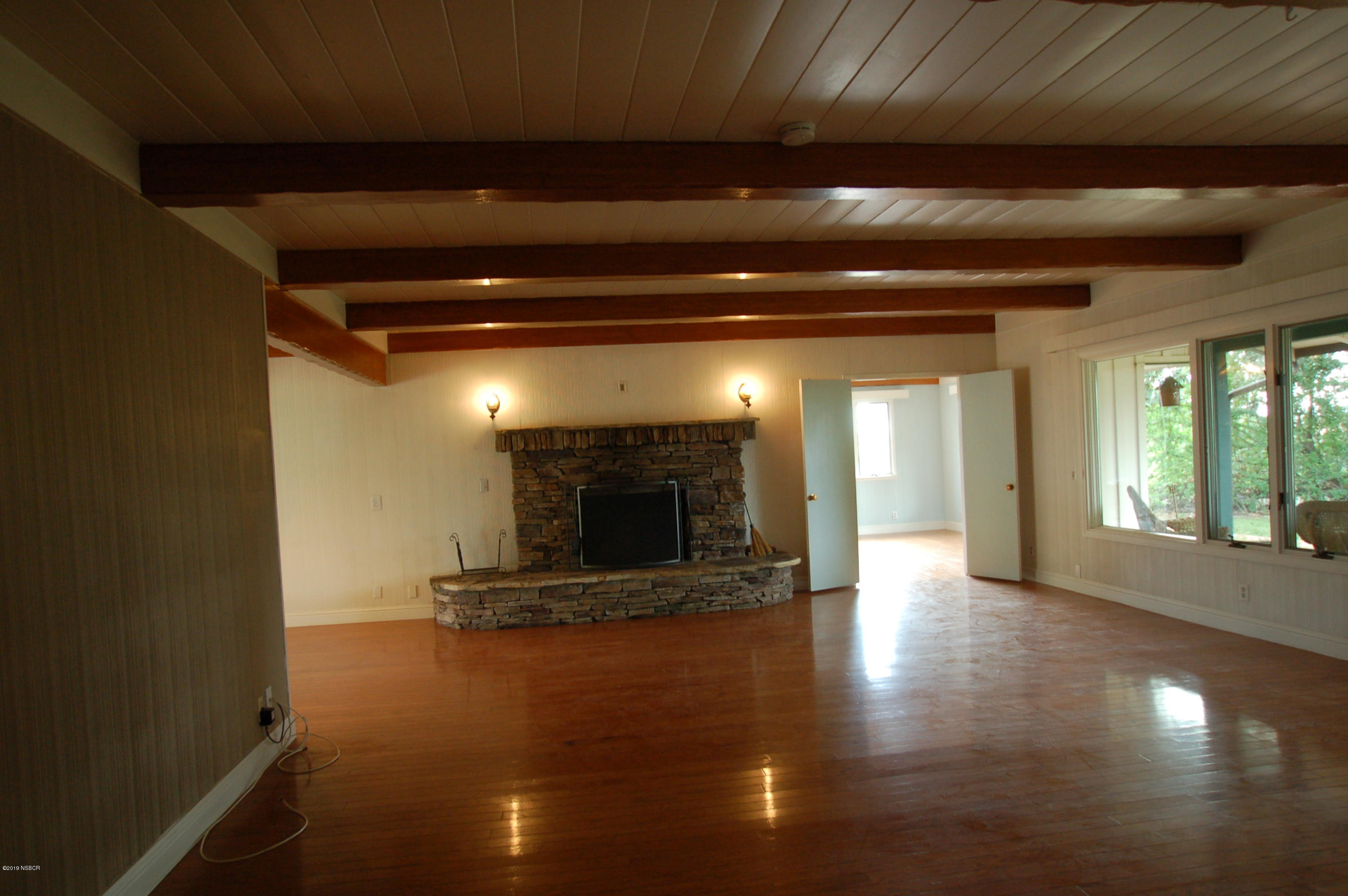 724 North Refugio Road Santa Ynez, CA 93460 - Photo 11 of 25 a view of an empty room with wooden floor and a floor to ceiling window