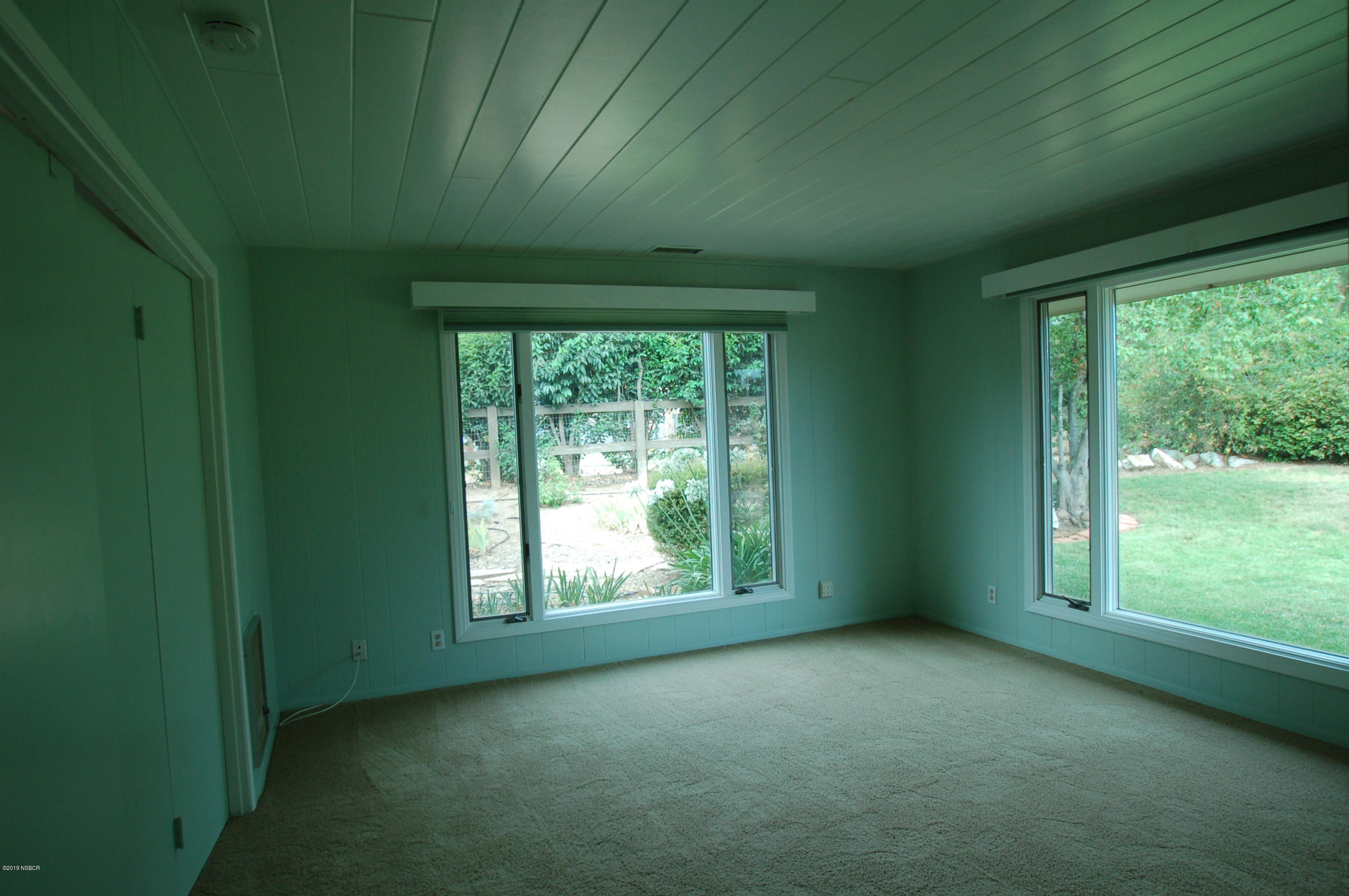 724 North Refugio Road Santa Ynez, CA 93460 - Photo 10 of 25 a view of empty room with green walls and floor to ceiling window