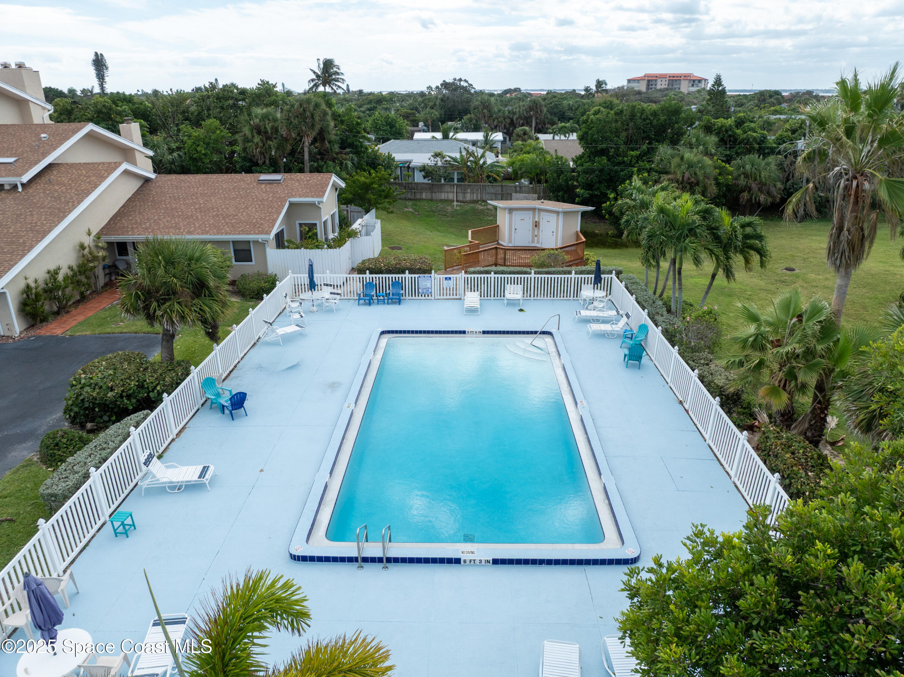 101 La Costa Street, Unit 6B Melbourne, FL 32951 - Photo 19 of 24 an aerial view of a house with a yard and lake view