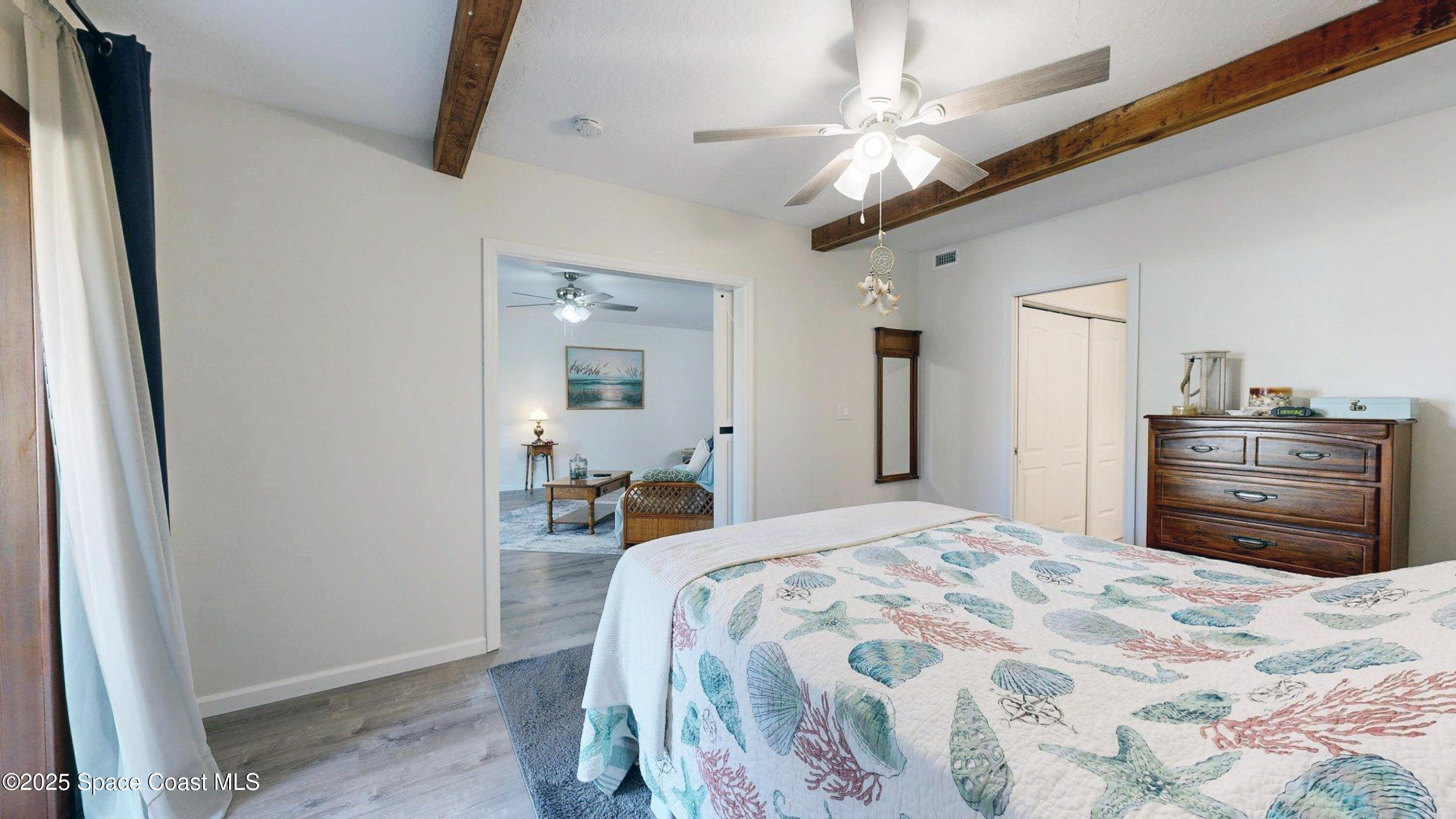 101 La Costa Street, Unit 6B Melbourne, FL 32951 - Photo 7 of 24 a bedroom with a bed and a chandelier