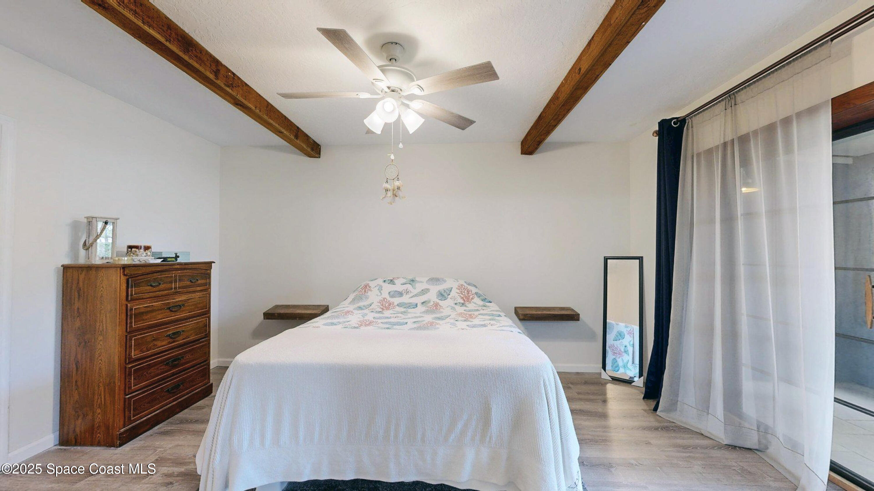 101 La Costa Street, Unit 6B Melbourne, FL 32951 - Photo 8 of 24 a bedroom with a bed and a chandelier