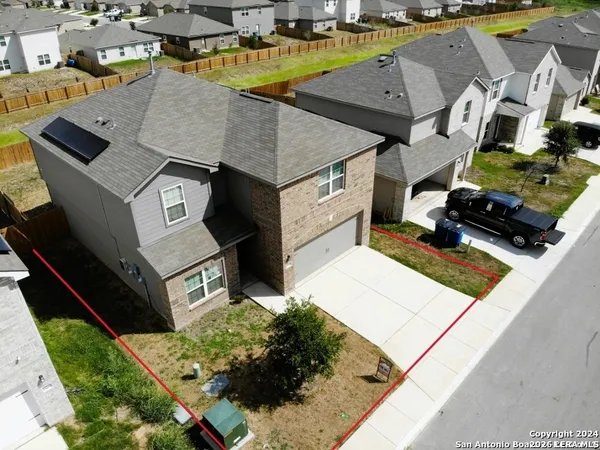 an aerial view of residential houses with outdoor space