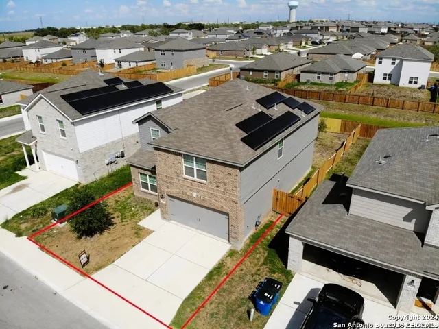 an aerial view of a house with swimming pool and ocean view