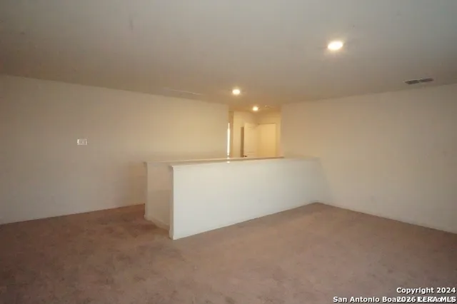 an empty room with a empty space and windows