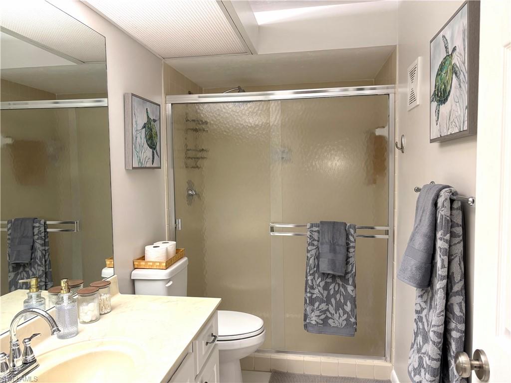 5841 Rattlesnake Hammock Road, Unit I203 Naples, FL 34113 - Photo 23 of 24 a bathroom with a sink toilet and shower
