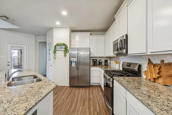 a kitchen with a sink stove and refrigerator