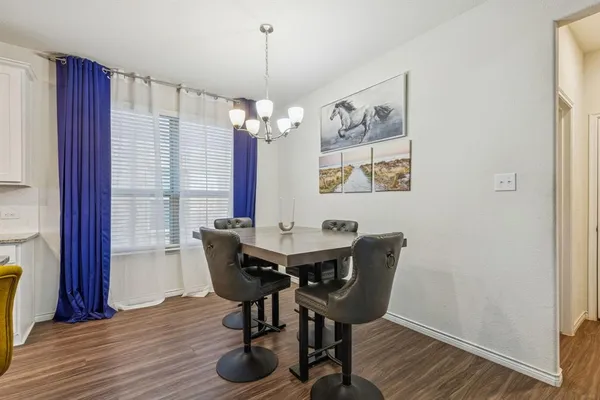 a view of a dining room with furniture wooden floor and chandelier