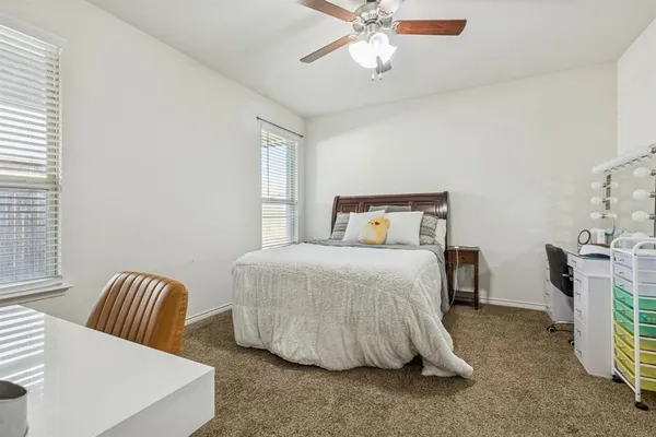 a bedroom with a bed and ceiling fan