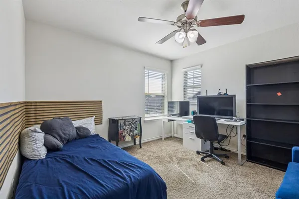 a bedroom with a workspace