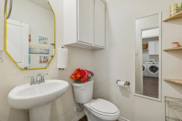 a bathroom with a sink mirror and toilet