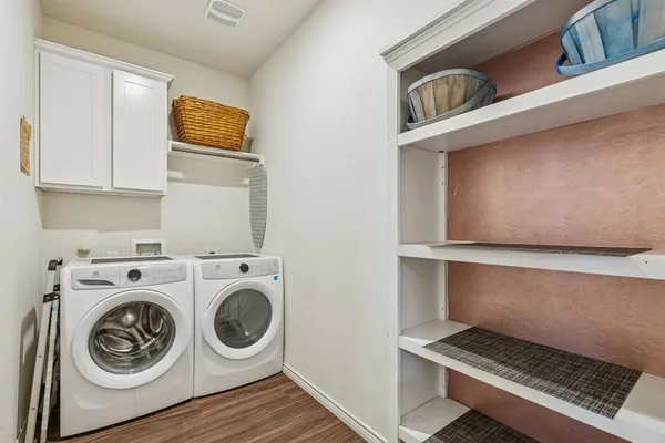 a utility room with sink dryer and washer