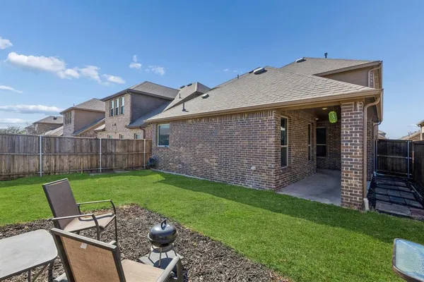 a view of a deck with a table and chairs with wooden fence