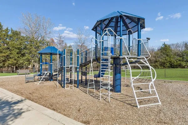 a view of a house with a yard and potted plants