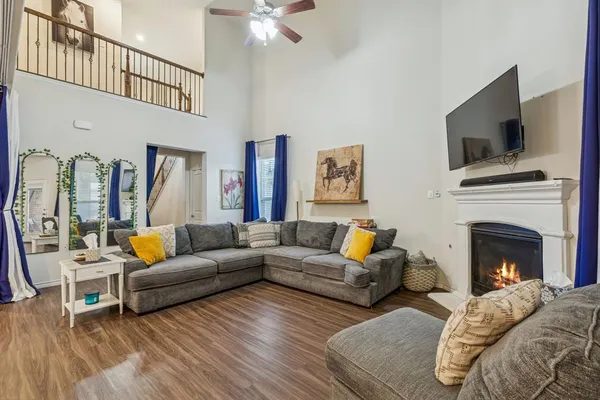 a living room with furniture fireplace and flat screen tv