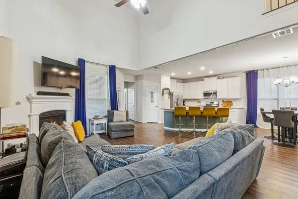 a living room with furniture kitchen and a flat screen tv