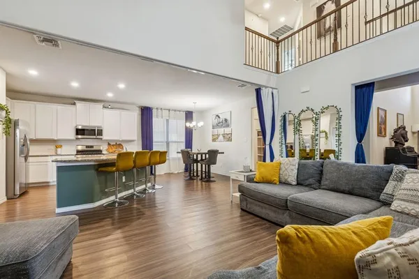 a living room with furniture kitchen view and a dining table