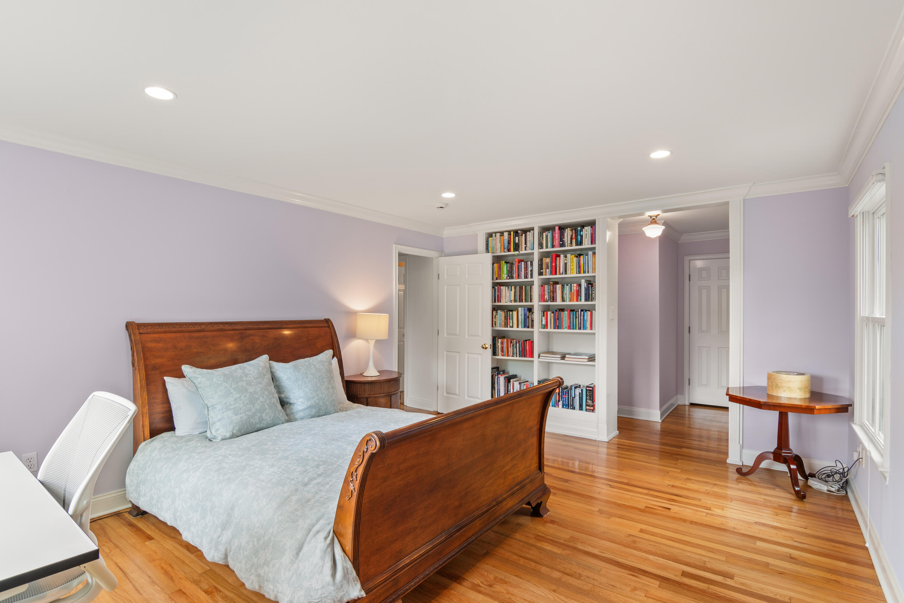 3 Old Field Road Rowayton, CT 06853 - Photo 13 of 29 a bedroom with a bed and a bookshelf with wooden floor