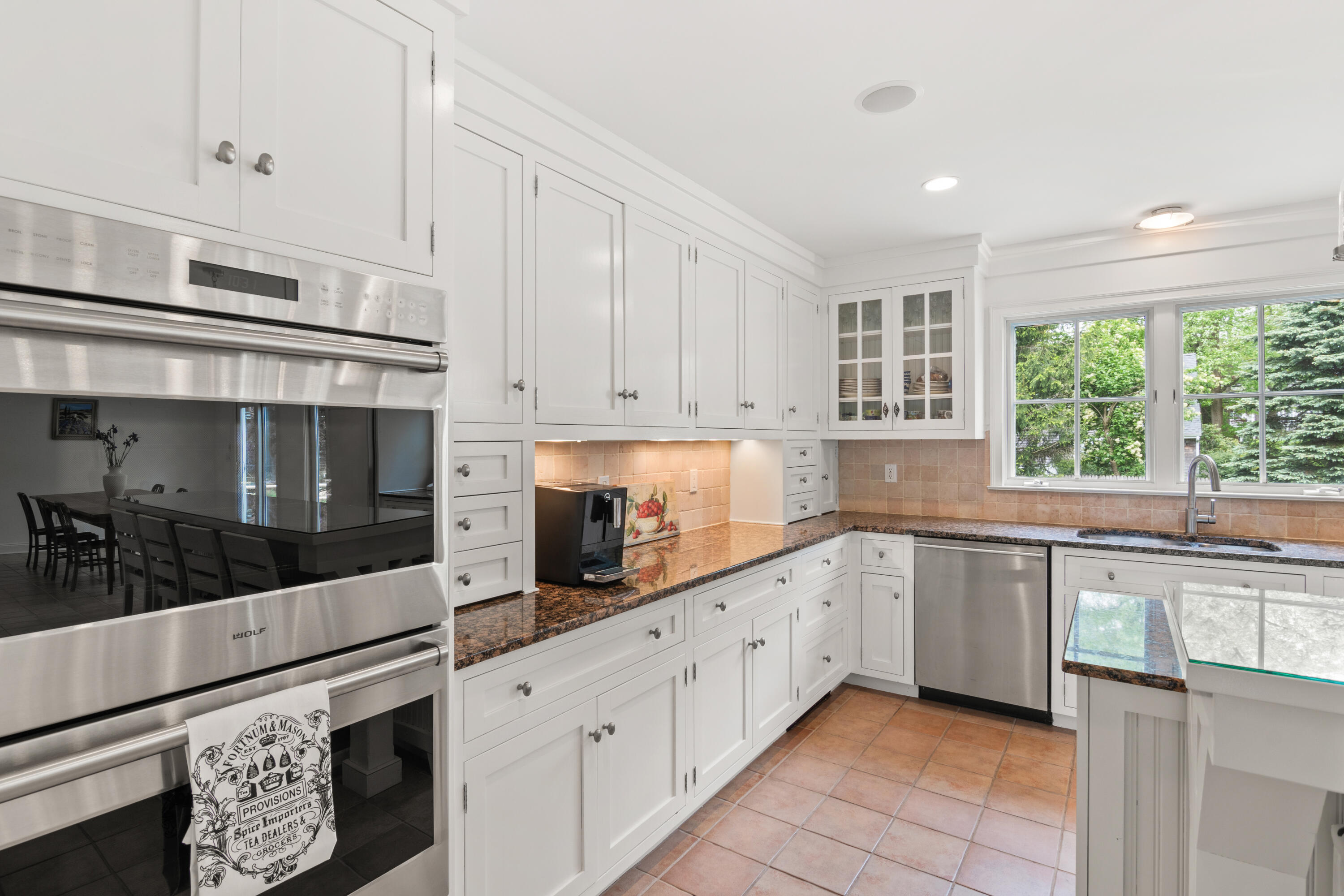 3 Old Field Road Rowayton, CT 06853 - Photo 5 of 29 a kitchen with stainless steel appliances granite countertop white cabinets and window