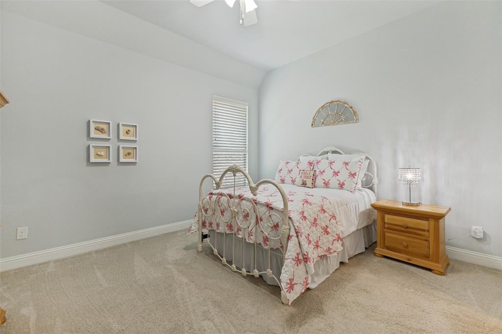 506 Life Spring Drive Rockwall, TX 75087 - Photo 26 of 36 a bed sitting in a bedroom next to a lamp