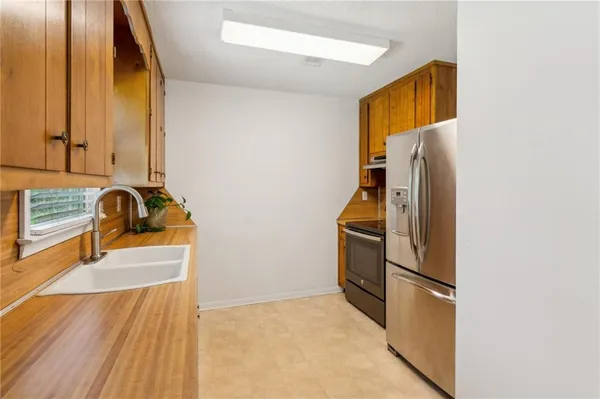 a kitchen with a refrigerator and a sink