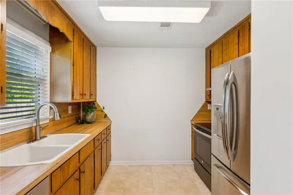 a bathroom with a granite countertop sink and a large mirror