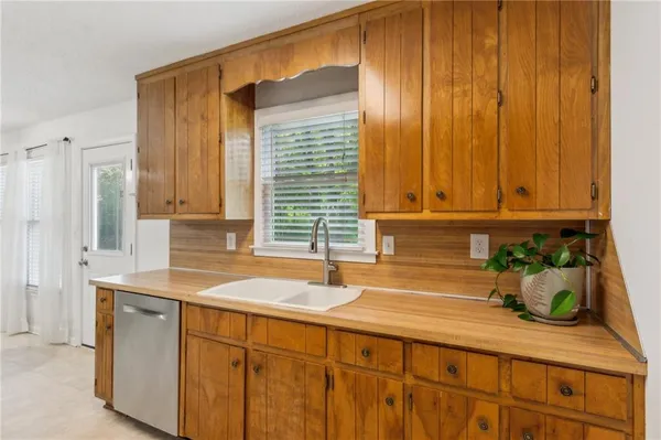 a kitchen with stainless steel appliances a sink and cabinets