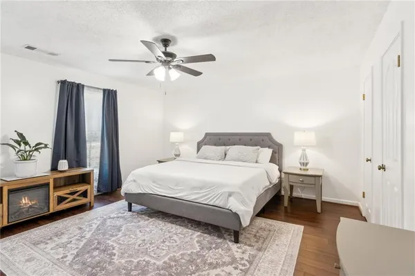a bedroom with a bed lamps and a fireplace