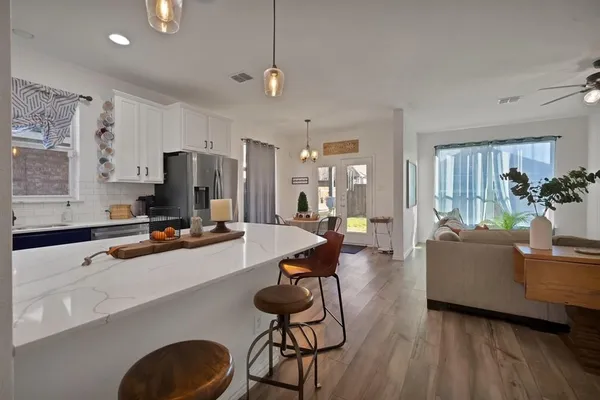 a kitchen with counter top space a sink appliances and cabinets