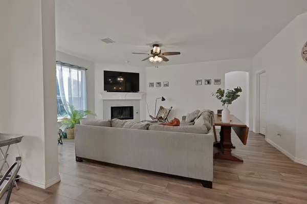 a living room with furniture a fireplace and a flat screen tv