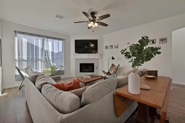 a living room with furniture and a chandelier