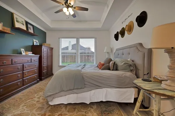 a bedroom with a bed and a large window