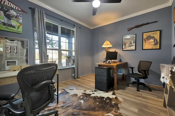 an empty room with ceiling fan and window