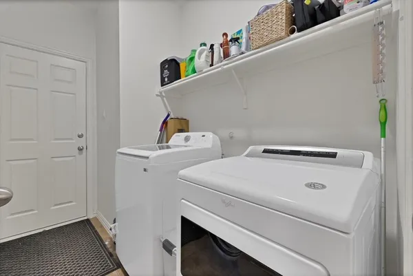 a bathroom with a toilet a sink a mirror and vanity