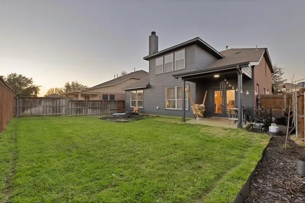 an aerial view of multiple houses with yard
