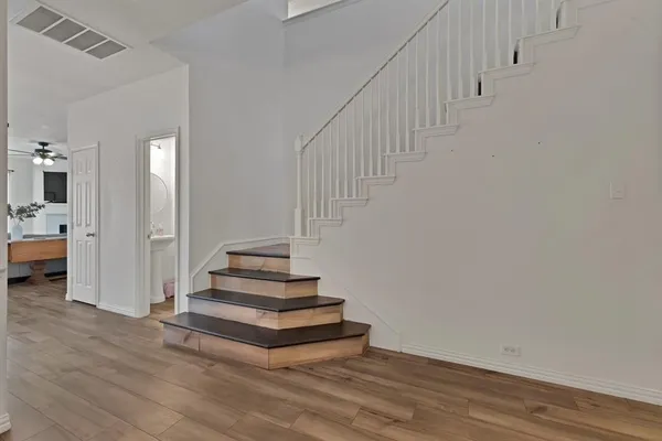 a view of entryway and hall with wooden floor