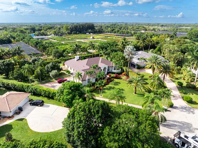 an aerial view of residential house with outdoor space and lake view in back