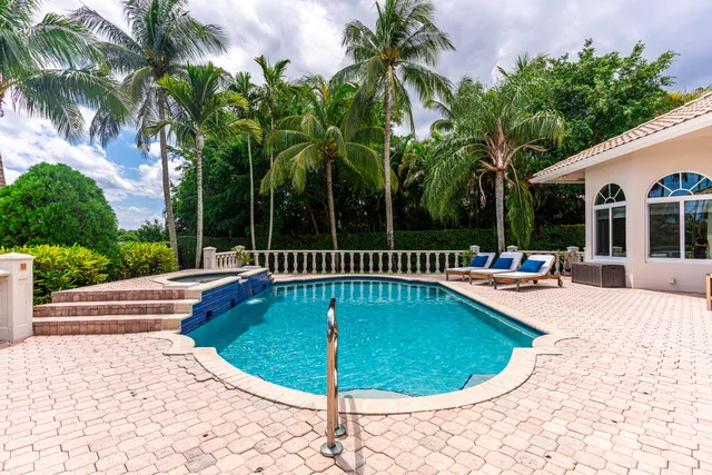 a view of swimming pool with seating area and potted plants