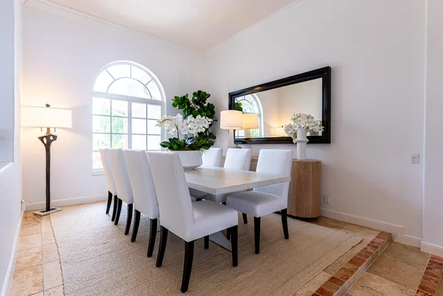 a view of a dining room with furniture and window