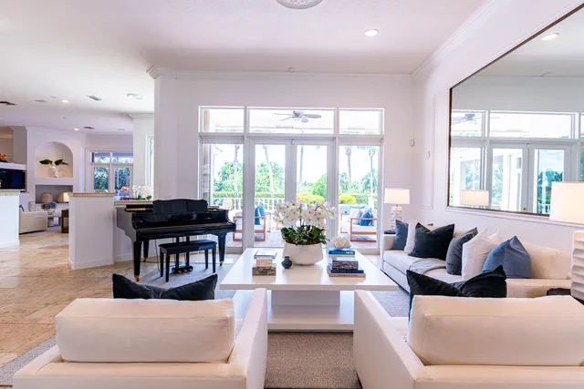 a living room with furniture and large windows