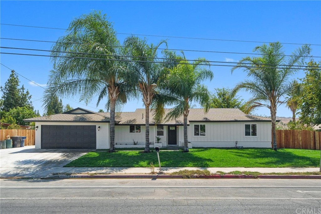 7770 Wells Avenue Riverside, CA 92503 - Photo 1 of 1 a view of a house with a yard and palm tree